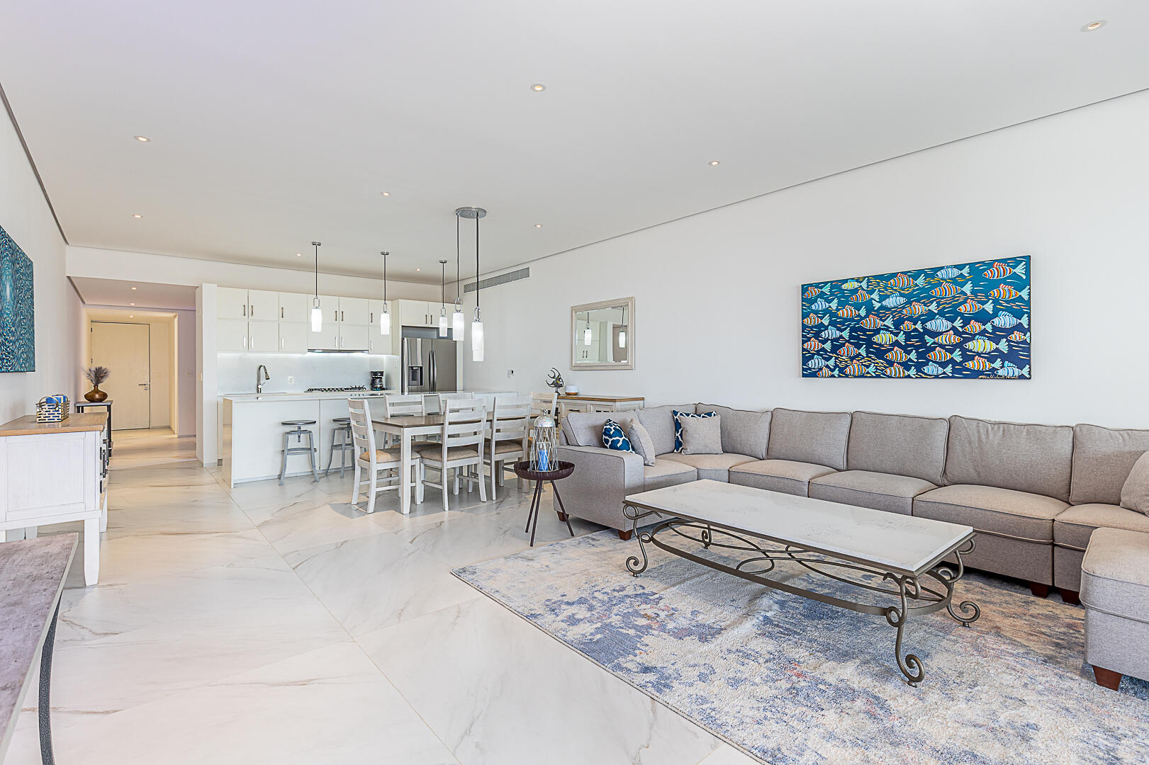 Club Campestre Cora One of the lowest-priced furnished residences currently available in Cora, this 2024-built condo is move-in ready and located within Club Campestre in San José del Cabo. The floor plan offers 3 bedrooms and 3.5 baths with approximately 1,841 sq ft of interior living space. Bright, modern interiors feature large-format tile flooring, an open-concept kitchen with island seating, and expansive sliding glass doors that connect seamlessly to oversized private decks. The interior design emphasizes clean lines, neutral finishes, and a cohesive open layout that connects the kitchen, dining, and living areas into a single, light-filled space. The kitchen is centered around a large island with quartz-style surfaces, modern cabinetry, and pendant lighting, opening directly to the main living area for easy entertaining. Floor-to-ceiling sliding glass doors extend the living space outdoors, creating a strong indoor-outdoor connection and allowing natural light to flow throughout the residence.Living and dining areas are furnished with contemporary pieces scaled appropriately for the space, complementing the modern architectural style seen throughout the development. Bedrooms are well-proportioned and designed for privacy, while bathrooms feature glass-enclosed showers and streamlined finishes consistent with the home's overall aesthetic. Privacy blinds, LED televisions with integrated switching, and thoughtfully placed lighting add functionality while maintaining a clean visual profile.Outdoor living areas are a standout feature, with expansive decks and patios offering generous space for seating, dining, and relaxation while overlooking the community's architectural landscaping and surrounding natural terrain.. Two covered on-property parking spaces include electricity and water connections suitable for electric vehicle charging or vehicle washing, and a private 10x10x14 storage locker with electricity provides secure owner storage.Cora is a gated, master-planned community within Campestre San José, featuring contemporary architecture and resort-style amenities visible throughout the property. Community offerings include a large swimming pool with integrated lounging areas, a hot tub, fitness center, indoor children's play area, and an enclosed dog park, all supported by 24/7 security. The Campestre San José golf course is approximately 0.5 miles away, and the private beach club on the Sea of Cortez is roughly 2.5 miles from the residence, subject to membership terms.Dining, recreation, and services are easily accessible, with Flora Farms approximately 2.8 miles away, Acre Restaurant about 3.0 miles, and the Historic Art District of downtown San José del Cabo roughly 4.5 miles from the property. Beachfront dining along the Tourist Corridor, including venues such as Veleros Beach Club and 7 Seas Grille & Seafood, is approximately 6.5 miles away, while Los Cabos International Airport is about 10.5 miles from the residence.Offered fully furnished and... for sale
