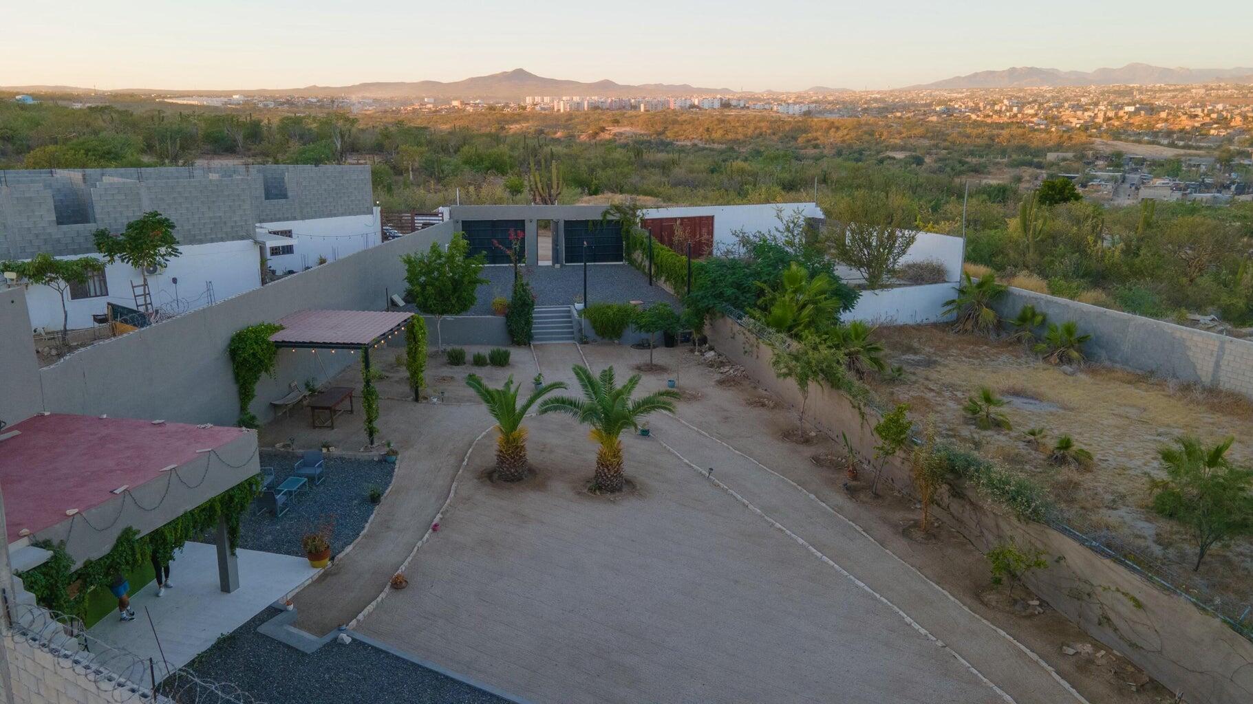 Club Campestre La Ventana GET TWO LOTS with this COMBINATION! Ideal for families, GROUPS, INVESTORS seeking rental or BUSINESS OPPORTUNITY! Sustainable construction Commune of Rammed Earth Homes has FOUR PRIVATE SUITES, two of which have kitchens, within two independent rammed earth homes. Enjoy shared amenities like SWIMMING POOL and fire pit area for outdoor enjoyment.Each unit features private entrances and quiet, comfortable interiors with kitchens and ensuite bathrooms. Rooftop terraces offer ocean – Sierra San Pedro Martir, Cabo San Lucas, BS