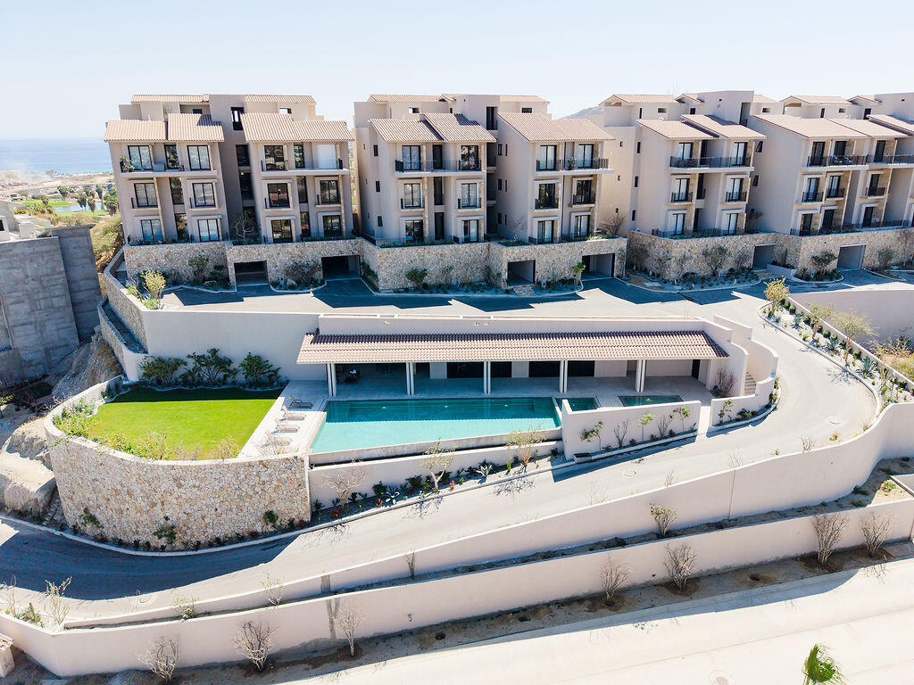 Club Campestre Costarena Welcome to Costarena Boutique Residences. Nestled in the exclusive community of Club Campestre San Jose, this collection of 39 resort-style condominiums is the epitome of understated elegance. A private community meticulously designed by renowned Mexican architects Carranza/Ruiz to offer an elevated lifestyle. Intimately scaled at seven three-story towers over two and a half acres, the vision of these homes is rooted in the natural world and seamlessly integrates indoor-outdoor living. Enjoy the tranquility and beauty of luxury coastal living with convenient proximity to all San Jose has to offer. The open floor plan of this stylish two-bedroom, two-bathroom residence makes Baja indoor-outdoor living easy. Units are beautifully appointed with custom white oak carpentry, Italian porcelain floors, and double-glazed floor-to-ceiling windows. The open-concept living and dining areas flow seamlessly onto an expansive terrace and are complemented with a fully equipped Italian kitchen complete with luxury appliances, a breakfast bar, and soft close hinges. Enjoy the soft ocean breeze from the primary bedroom with direct access to the terrace, an ensuite bathroom with double vanities, and a large walk-in closet. The secondary bedroom offers privacy at the opposite end of the residence. Two parking units are included in the purchase. One underground has ample space for personal storage or a golf cart, and the other is above ground. Both are easily accessible by elevator. – Ave. Vista Hermosa SN, San Jose del Cabo, BS